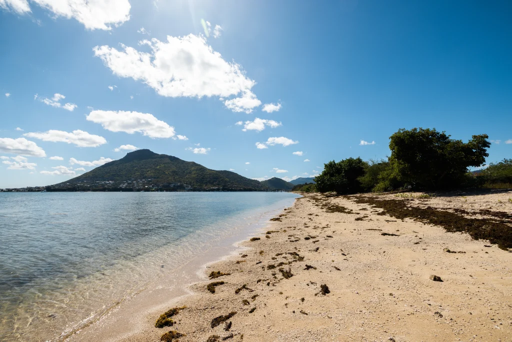 Mauritius tropical beach coastline with mountain views for island travel advice and vacation planning