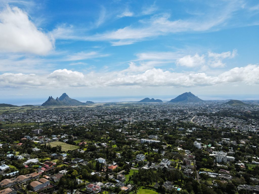 Aerial view of Mauritius island showing cityscape, mountains, and coastline for travel map and island navigation planning